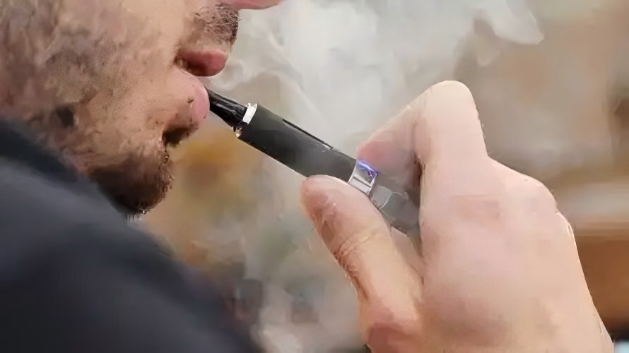 A person smoking a disposable vape