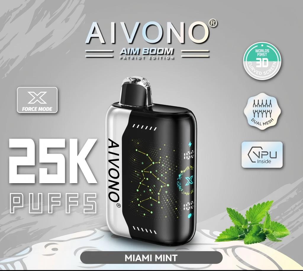 An AIVONO AIM BOOM Patriot Edition disposable vape device in Miami Mint flavor, featuring a sleek black and silver design with a constellation - like pattern. It’s labeled “25K PUFFS” and highlights features like “X FORCE MODE”, “WORLD’S FIRST 3D CURVED SCREEN”, “DUAL MESH”, and “NPU Inside”, with fresh mint leaves nearby.